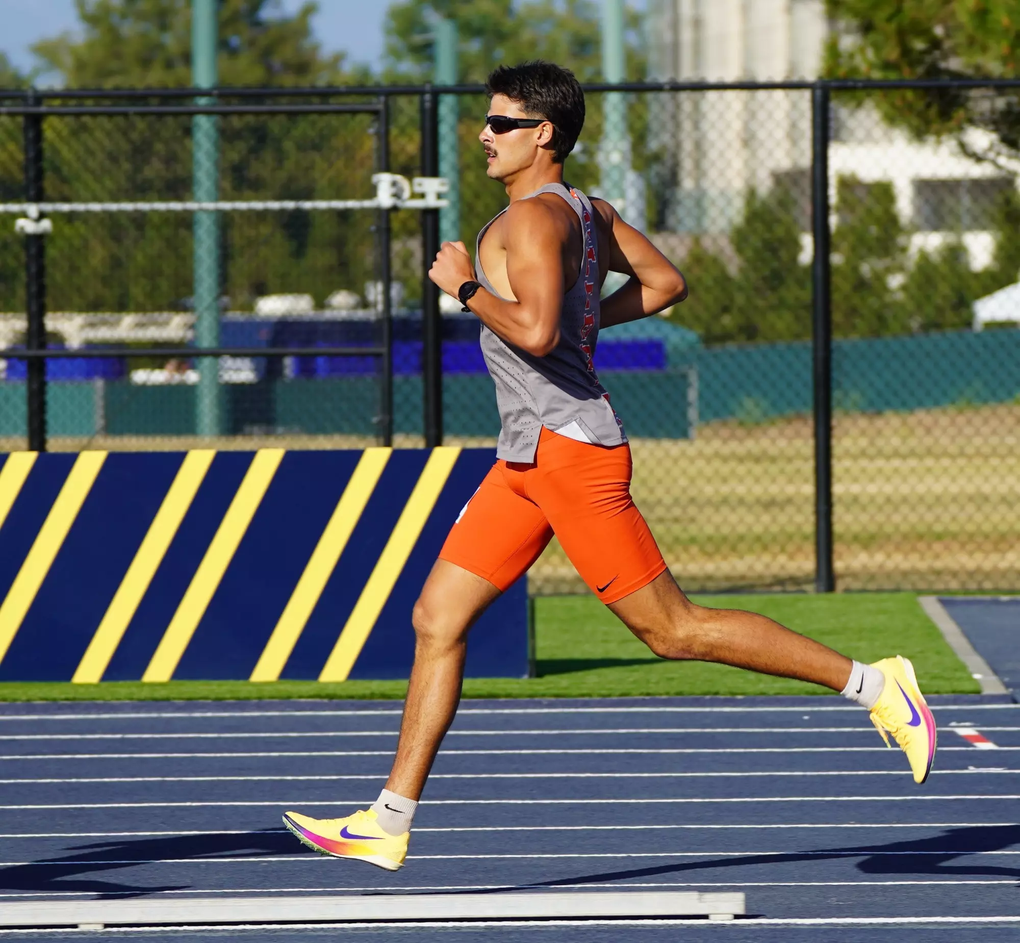 Keith Orona sprinting on the track in Cal State Fullerton kit
